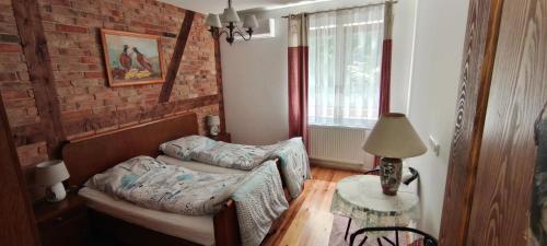 a living room with a couch and a table at Cztery Pory Lasu in Silna Nowa