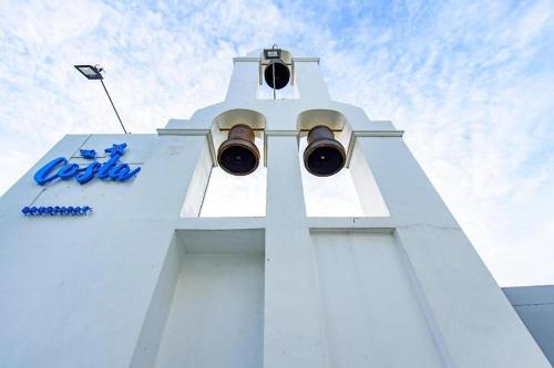 a white tower with a traffic light on it at Costa Village Jacuzzi Bangsaray in Bang Sare