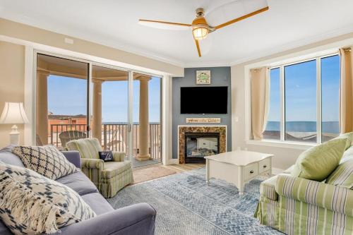 a living room with a fireplace and a tv at Belmont Towers 407 in Ocean City