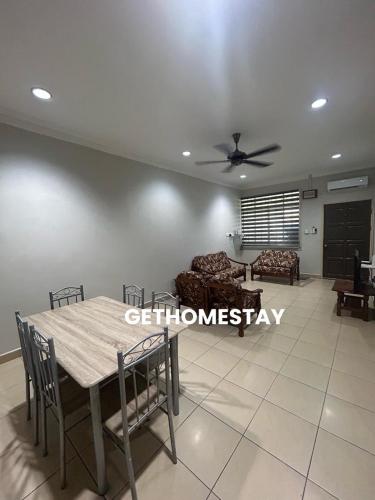 a dining room and living room with a ceiling fan at Gethomestay Keningau in Keningau