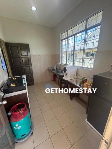 a small kitchen with a sink and a counter at Gethomestay Keningau in Keningau