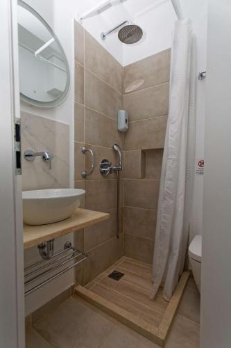a bathroom with a sink and a shower at Argonaftis Spetses in Spetses