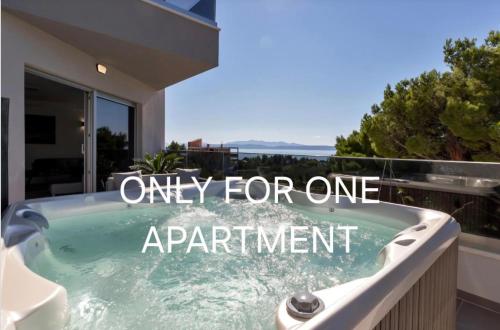 a bath tub with a sign that reads only for one apartment at Luxury Apartments Podgora in Podgora