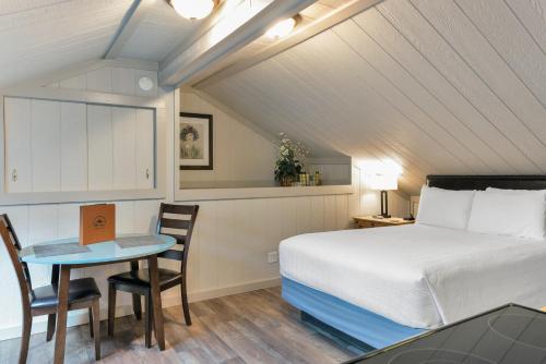 a bedroom with a bed and a table and chairs at Timber Ridge Lodge Ouray in Ouray