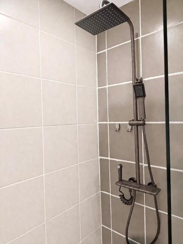 a shower with a shower head in a bathroom at Paladium Iloilo Smart Home Condo in Iloilo City