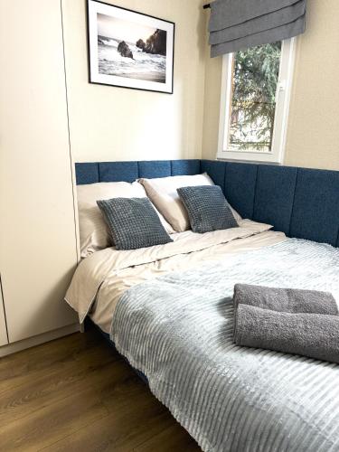 a large bed in a bedroom with a mirror at Sosnowe Tarasy in Boszkowo-Letnisko