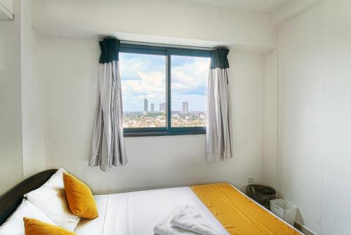 a bedroom with a bed and a window at Lovish luxury villa in Colombo