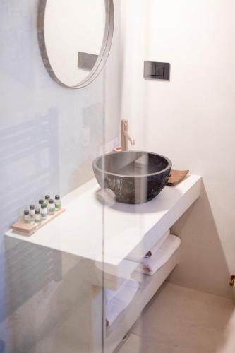 a bathroom with a sink and a mirror at Petra & Fos Boutique Hotel & Spa in Neo Itilo