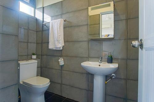 a bathroom with a toilet and a sink at Lovish luxury villa in Colombo