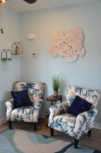 a living room with two chairs and a fan at 2BR Cozy Cottage Private Dock in Davis