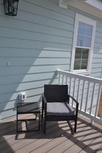 a bench sitting on a porch next to a house at 2BR Cozy Cottage Private Dock in Davis