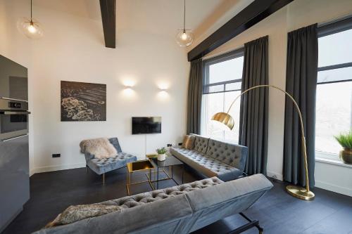ein Wohnzimmer mit einem Sofa und einem Tisch in der Unterkunft "DE BANK" - Hotel Apartments in Harlingen