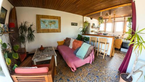 a living room with a couch and a table at Guesthouse Évasion in Contis-les-Bains