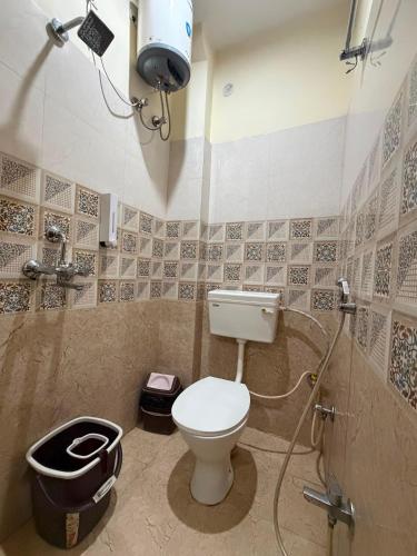 a bathroom with a toilet and a shower in it at Kashi Vilas in Varanasi