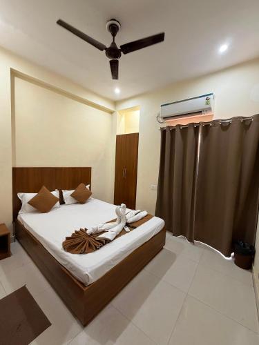 a bedroom with a bed with a ceiling fan at Kashi Vilas in Varanasi