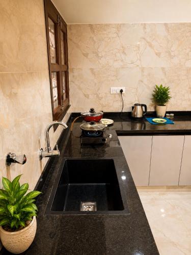 a kitchen with a sink and a counter top at Pinto Eden Home Stay 5 Star Luxury Stay in Chikmagalur in Sangameswarpet