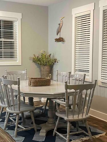 a dining room table with chairs and a bird on the wall at Waterfront Home 3BR King bed Private Dock in Smyrna