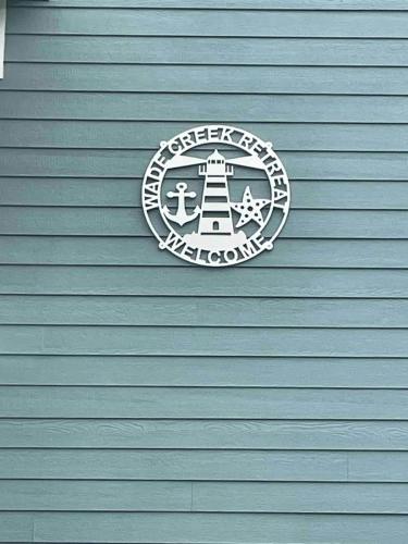 a sign on the side of a building at Waterfront Home 3BR King bed Private Dock in Smyrna