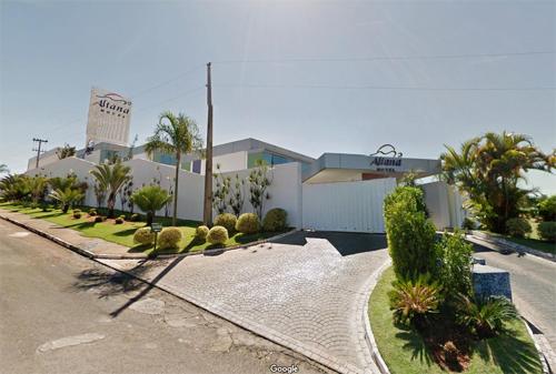 a house with a lot of plants in front of it at Altana Motel in Brasília