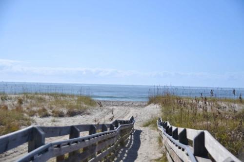 a path to the beach with the ocean in the background at Steps to Beach 2BR 2BA duplex in Atlantic Beach