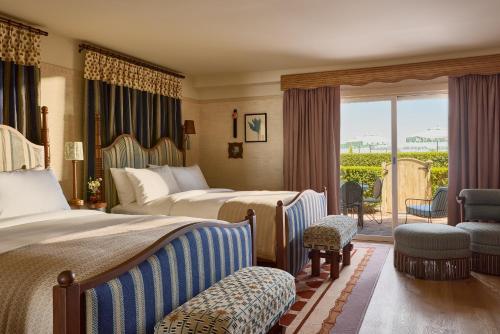 a hotel room with two beds and a balcony at Faraway Sag Harbor in Sag Harbor