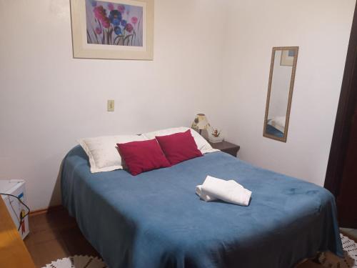 a bedroom with a bed with two towels on it at Marins Pousada - Campos do Jordão in Campos do Jordão