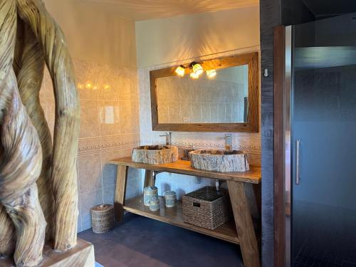 a bathroom with two sinks and a mirror at La Belle du Sud in Saint-Joseph