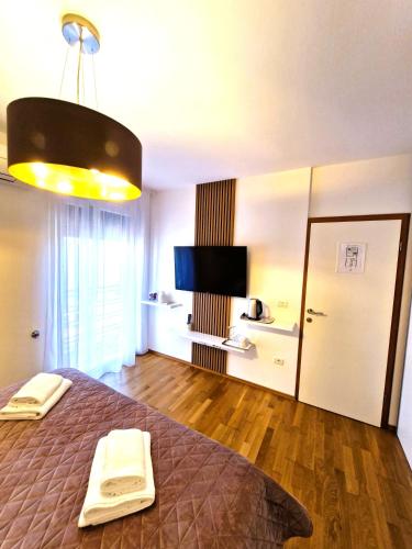 a bedroom with a bed and a television in it at Rooms Hana Rovinj in Rovinj
