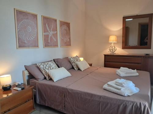 a bedroom with a large bed and a couch at Villa Aurora in Ispica