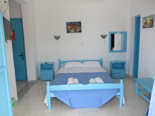 a bedroom with a blue bed with two blue cabinets at Iliotropio Ligia in Ligia