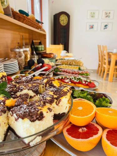 a table with many plates of food and oranges at Cudne Manowce in Wisła