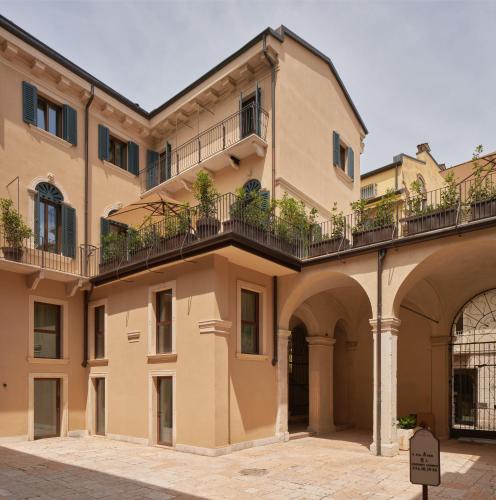 a large building with a balcony on the side at Homy Livia Verona in Verona