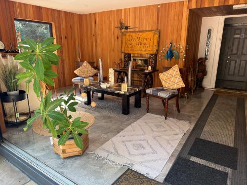 a living room with wooden walls and a table and chairs at Da Vinci Guest House Gatwick Guest Parking, A Real Gem in Crawley