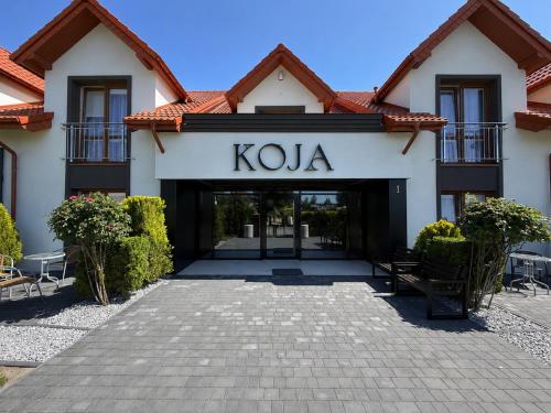 a building with a kola sign on the front at Koja in Rowy
