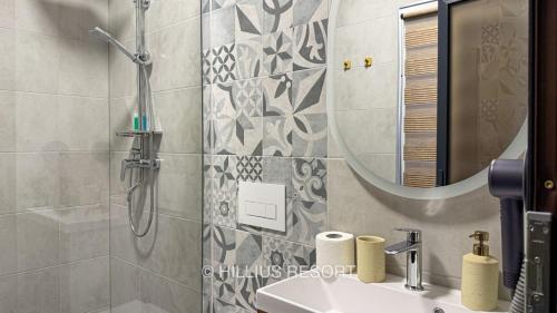 a bathroom with a shower and a sink and a mirror at HILLIUS Resort in Solotvyno