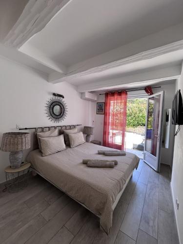 a bedroom with a large bed and a window at Maxima Sunset in Sainte-Maxime