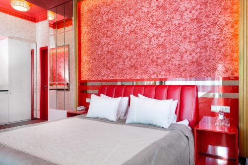 a red bed in a room with a red wall at Road Star Hotel in Dnipro