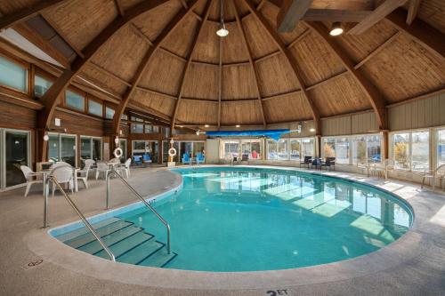 a large swimming pool in a building with a wooden ceiling at Round Barn Lodge in Spring Green