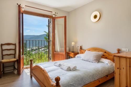 a bedroom with a bed and a large window at Casa Rural Uria in Gavín