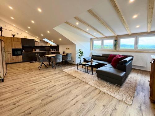 a living room with a couch and a table at LuxLife - Panorama Bergblick, Sauna, Balkon, Luxus Pur in Buchenberg