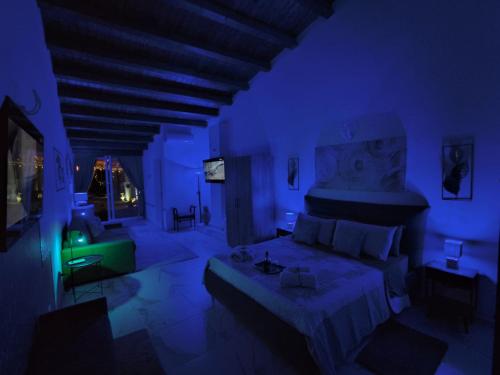a blue room with a bed and a couch at THE KING'S LOFT Loft del Rè Sebi in Villasmundo
