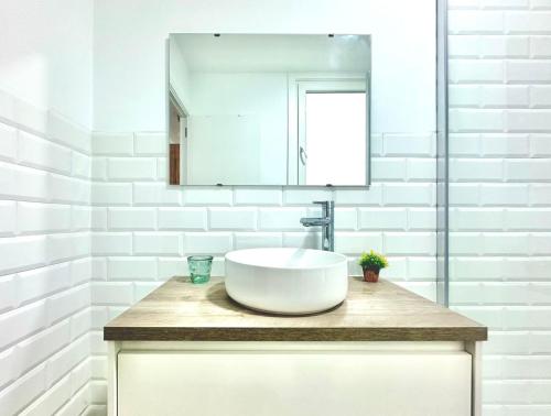 a white bathroom with a sink and a mirror at Olivo’S in Ferrol