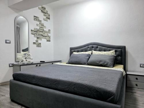 a bedroom with a large bed with a large mirror at Sweet Home in Pogradec