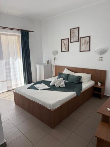 a bedroom with a bed with two towels on it at Vila Cristina in Mamaia Sat/Năvodari