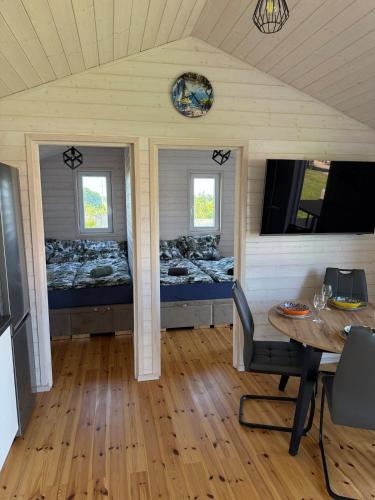 a room with two beds and a table in a room at BananaHouse Junior in Kruszwin