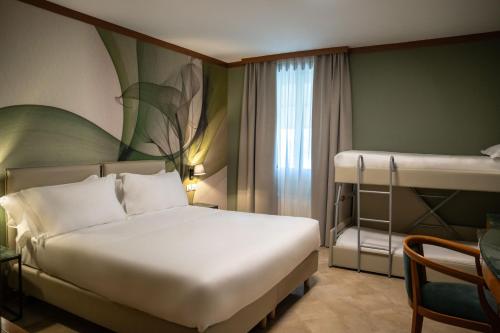 a bedroom with a bed and a bunk bed at Spazio Origine - Studio Hotel in Monopoli
