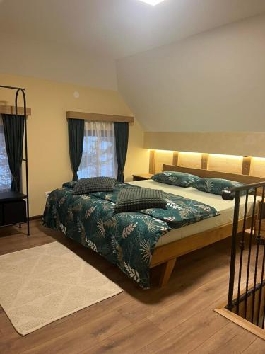 a bedroom with a large bed and a window at Tara Saric Duplex in Kaludjerske Bare
