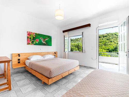a bedroom with a bed and a window at Bodini's Rooms in Himare