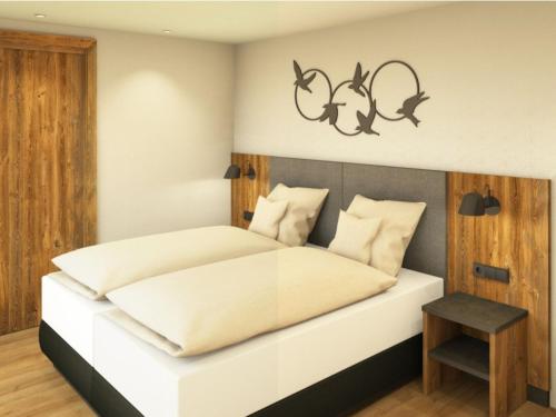 a bedroom with a white bed and a table at App. Sun Burdengeja in Selva di Val Gardena