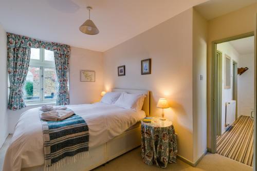 a bedroom with a bed and a window at Trevadlock Manor by Smart Welcomes in Launceston